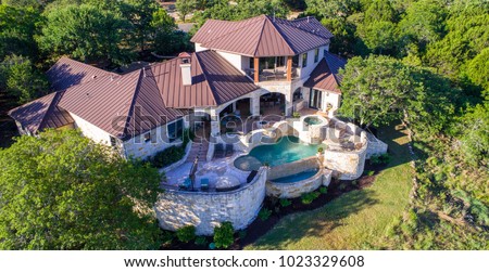 Rich Luxury mansion on large lot of land with Texas hill country landscape and surrounding green surroundings of the ranch country home with infinity pool and wealthy real estate living