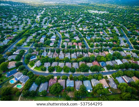 aerial amazing gorgeous view over Central Texas suburb housing community with rows of homes and thousands of new houses suburbia Austin Texas USA