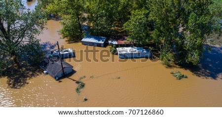 Massive Flooding Home under water from Hurricane Harvey in La Grange , Texas Flooding and destruction after Hurricane Harvey flooded neighborhood a group of houses with water up to the roof