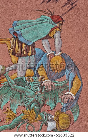 Devil takes Doktor Faust to hell - scene on a wall in Staufen,Germany where the real Dr. Faust has lived till he died in this house