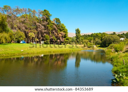 Beautiful landscape of campingsite with green forest near a stream  in Villa Ventana, Sierra de la Ventana, Argentina