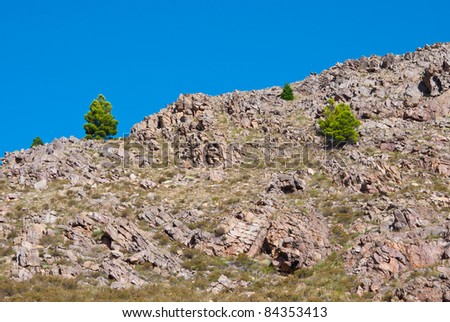 Beautiful rocky landscape of hill with trees and blue sky in Sierra de la Ventana, Argentina