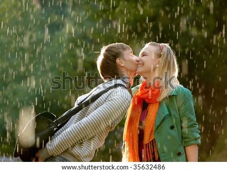 kissing in the rain black and white. stock photo : kiss under the
