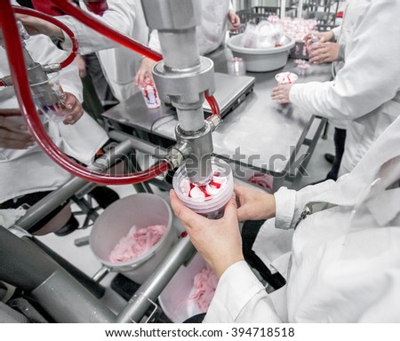 Production of ice-cream at milk factory with workers