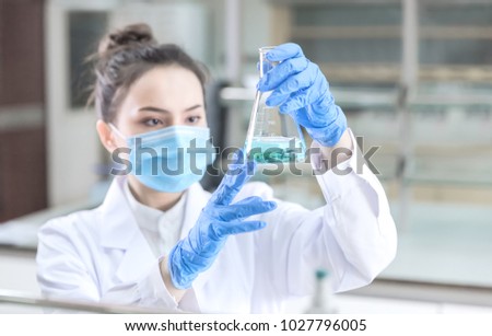 Female scientist looking at the scientific sample in the laboratory