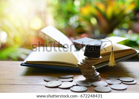 Graduation cap on saving coins for concept finance and education