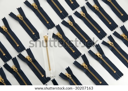 standout, be different, be daring:  white zipper among rows of blue ones, isolated on white background