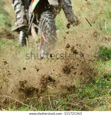 Flying mud from moving motorcycleÃ?ÃÂ¢??s enduro wheel.