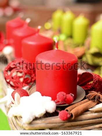 Christmas decoration with red and green candles closeup.