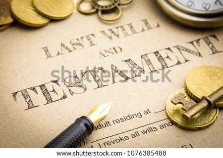 Close up Vintage of Black pen, Gold coins money, Vintage gold key and vintage clock on Last will and testament document concept