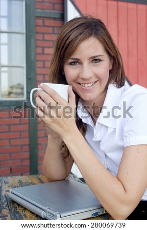 Woman with laptop and coffee cup