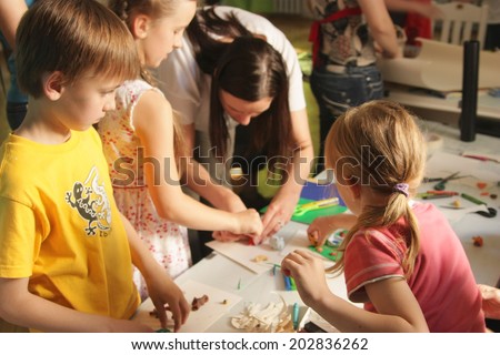 KAUNAS, LITHUANIA - JUNE 29: Unidentified kids with tutor during animation workshop on June 29, 2010 in Kaunas, Lithuania