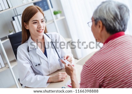 Asian doctor woman explaining old patient for taking medicine, asian medical concept