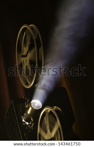 Film projector in smokey room.
