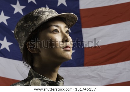 Military woman in front of US flag, horizontal