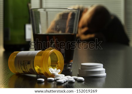 Passed out man with wine and prescription pills, horizontal
