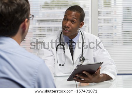 Young African American doctor consulting with patient, horizontal