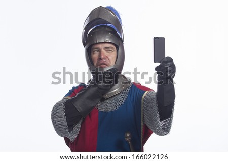Man in knight costume taking a selfie, horizontal - stock photo