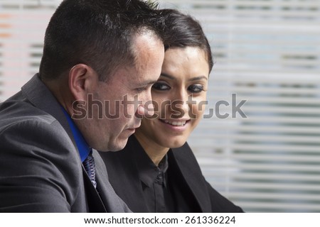 Hispanic man discussing business with Hispanic woman