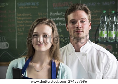 Portrait of 2 proud restaurant staff, close up