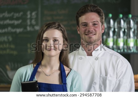 Portrait of a waitress and chef, smiling