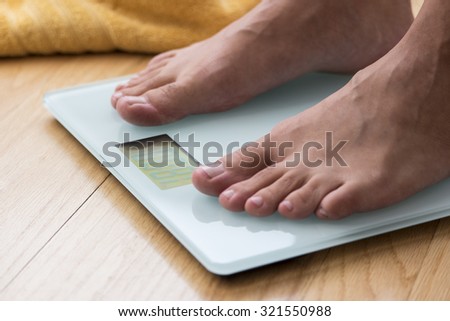 Portrait of male feet on a scale