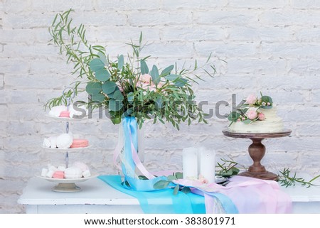 wedding cake decorated with flowers. Beautiful decoration for the wedding table. cheese bar on a wooden table. decorated buffet table. Serving fabulous wedding table in pink and blue color