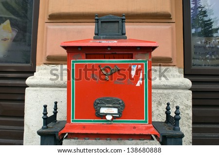 BUDAPEST, HUNGARY - MAY 6 : Post box with the emblem of the Hungarian Post Office in the Castle Hill at May 6, 2013 in Budapest, Hungary. Old style post box fitting to the cultural heritage district.