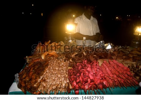 STONE TOWN, ZANZIBAR - FEBRUARY 5 : Night market 5 february, 2011. Stone Town, Zanzibar. Cooks prepare grilled seafood during the night market for the customers on the beach in Stone Town.