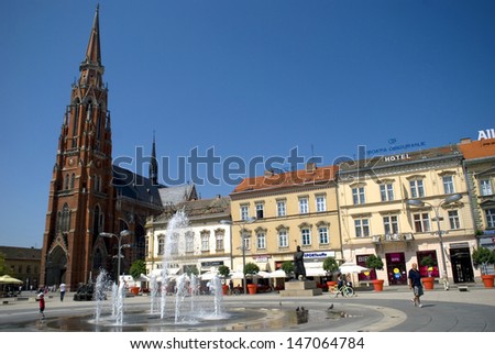 OSIJEK CROATIA July 19 Main square with the cathedral at July 19 2013 in Osijek Croatia Osijek is the capital city of Slavonia with mixed Hungarian Croatian architecture OSIJEK CROATIA July 19 Main square with the cathedral at July 19 2013 in Osijek Croatia Osijek is the capital city of Slavonia with mixed Hungarian Croatian architecture