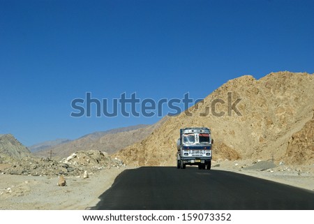 LADAKH, INDIA - OCTOBER 6: Truck on the road on October 6, 2013 in Ladakh, India. The mountainous region of Ladakh lacks railway, so road transport is the way to bring supply to the remote places.