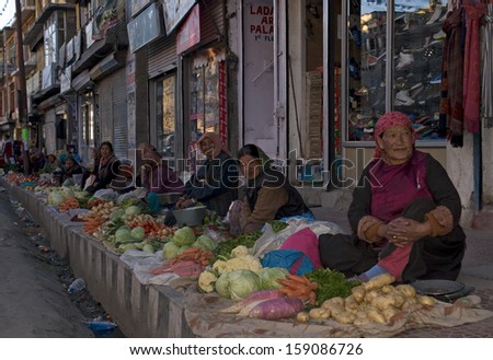 Leh, INDIA - OCTOBER 4: Market scene on October 4, 2013 in Leh, India. Local women sell fruits and vegetables on the street. Ladakh has harsh climate for food industry, most of them are imported.