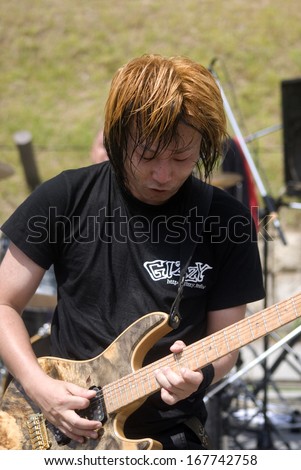 OSAKA, JAPAN - JUNE 19: Free Gizzy concert at Osaka Castle Park on June 19, 2013, Osaka, Japan. Open parks in Japan are favorite places for young bands to show their talents to the audience.