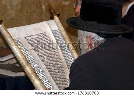 JERUSALEM, ISRAEL - DECEMBER 6: Orthodox Jewish man prays at the Western Wall on December 6, 2013, Jerusalem, Israel. The Wall is the holiest place for Jewish people. All of them go there to pray.