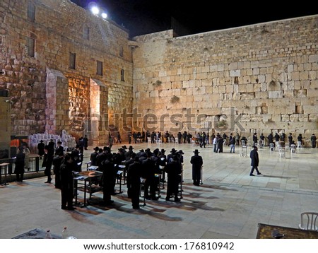 JERUSALEM, ISRAEL - DECEMBER 6: Orthodox Jewish men pray at the Western Wall on December 6, 2013, Jerusalem, Israel. The Wall is the holiest place for Jewish people.