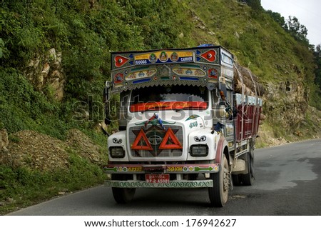 BHUTAN - SEPTEMBER 28: Trucks on the road on September 28, 2013, Bhutan. The mountains make impossible to use rail in Bhutan, so traffic is exclusively by road. Trucks are used for carrying stuff.