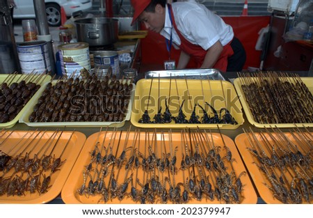 BEIJING, CHINA - JUNE 7: Donghuamen night market on June 7, 2014 in Beijing, China. The most famous night market in Beijing sells everything what moves from spiders to snakes.