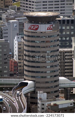 OSAKA, JAPAN - SEPTEMBER 15 : Highway goes through a building at 15 September 2014. Osaka Japan. There is not enough space in Japan, so highways must be built anywhere it is possible.
