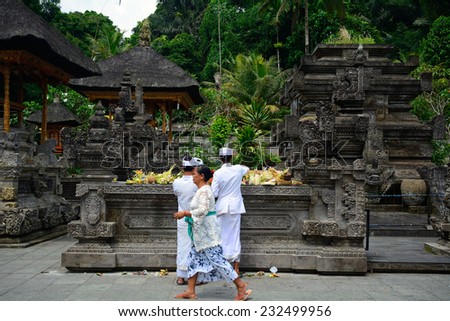 BALI, INDONESIA - NOVEMBER 12: Pilgrims at Tirta Empul Hindu temple on November 12, 2014 in Bali, Indonesia. Tirta Empul is famous pilgrim place because of the holy spring flowing inside.