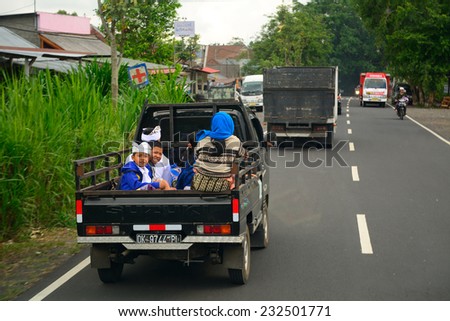 BALI, INDONESIA - NOVEMBER 12: People on the truck on November 12, 2014 in Bali, Indonesia. Rural transport in Bali includes riding the back of trucks.
