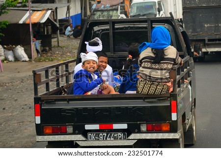 BALI, INDONESIA - NOVEMBER 12: People on the truck on November 12, 2014 in Bali, Indonesia. Rural transport in Bali includes riding the back of trucks.