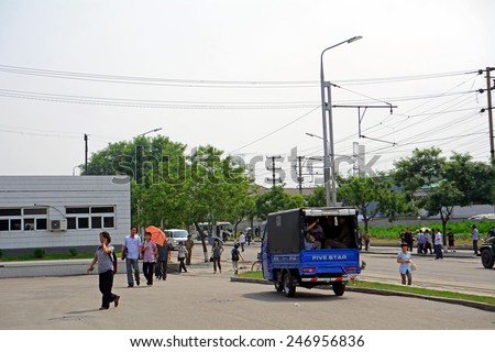 NORTH KOREA, PYONGYANG - JUNE 11: Public transports at June 11, 2014 in Pyongyang, North Korea. he result of lack of buses is that people travel on trucks.