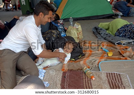 BUDAPEST - SEPTEMBER 1 : War refugees at the Keleti Railway Station on 1 September 2015 in Budapest, Hungary. Refugees are arriving constantly to Hungary on the way to Germany.