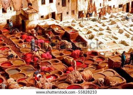 FEZ, MOROCCO - FEBRUARY 26: Local people painting leather at the tannery  by the ancient way at February 26, 2008 in Fez, Morocco.