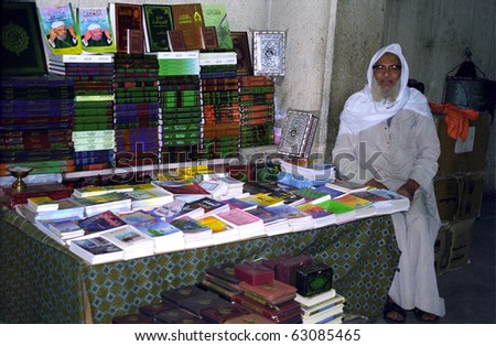 CAIRO, EGYPT - NOVEMBER 18 : Old arabic man sells Koran on the street at 18. November 1998. Cairo, Egypt. Koran is the Holy Book of Islam and is a must to have one piece for all muslim people.