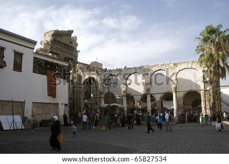 SYRIA, DAMASCUS - OCTOBER 20: Pilgrims gather next to Jupiter Temple ruins at October 20, 2010, Damascus, Syria. Pilgrims are ready to enter the Umayyad Mosque next to the Jupiter Temple ruins.