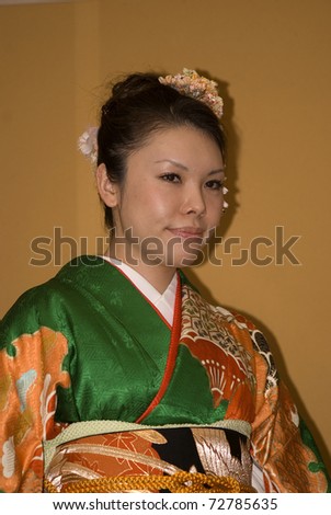 TOKYO - FEBRUARY 24: Young Japanese lady wears kimono on a fashion show on February 24, 2011 in Tokyo. Kimono is the traditional Japanese clothes woven of silk.