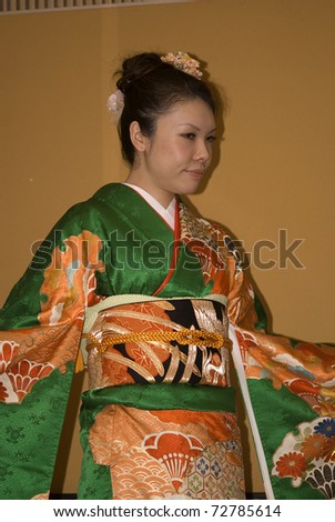 TOKYO - FEBRUARY 24: Young Japanese lady wears kimono on a fashion show on February 24, 2011 in Tokyo. Kimono is the traditional Japanese clothes woven of silk.
