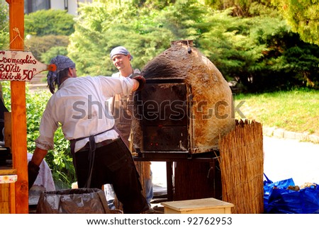 ETYEK, HUNGARY - MAY 25 : Bakers prepare old-style Hungarian bread at May 25, 2008 in Etyek, Hungary. During the Etyek Wine and Spirit Festival, as the territory is a famous wine region in Hungary.