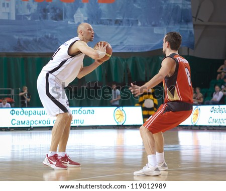 SAMARA, RUSSIA - MAY 11: Dmitry Domani of BC Krasnye Krylia with ball goes against a BC Ural player on May 11, 2012 in Samara, Russia.